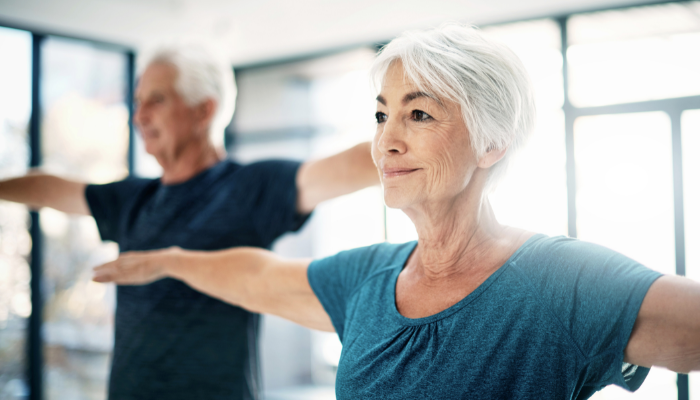 Older couple doing yoga