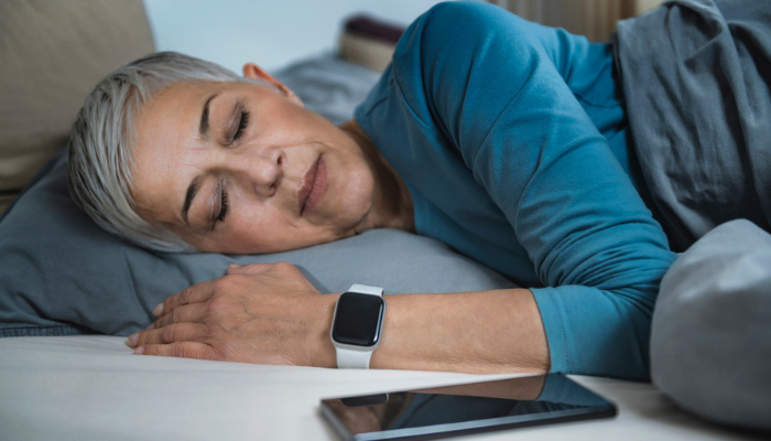 Woman sleeping wearing wearable technology