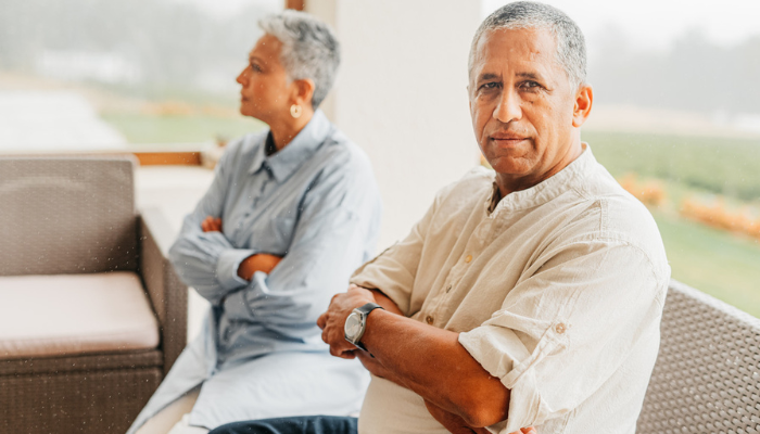 Older couple on couch discussing gray divorce