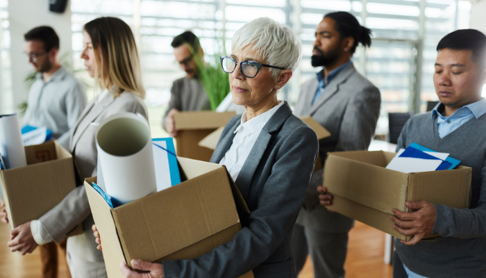 People unhappy holding boxes getting laid off at work