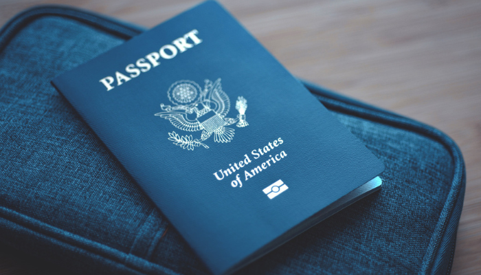 Passport and travel bag on table