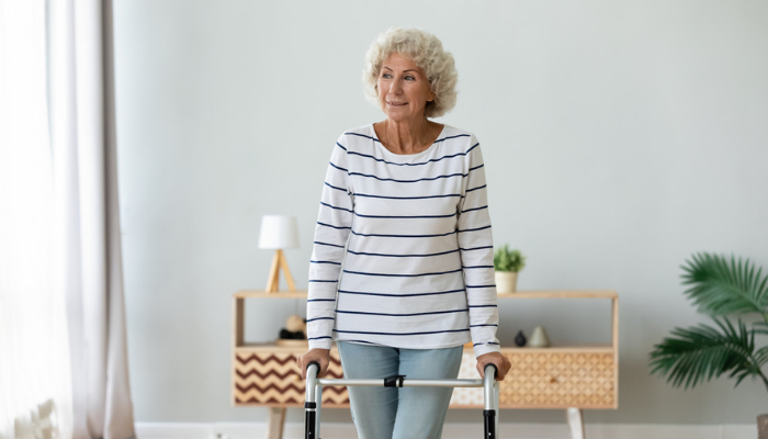 Older woman using a walker.