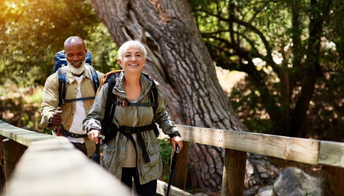 Happy interracial couple hiking outside