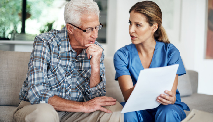 Man discussing home health contract with nurse.