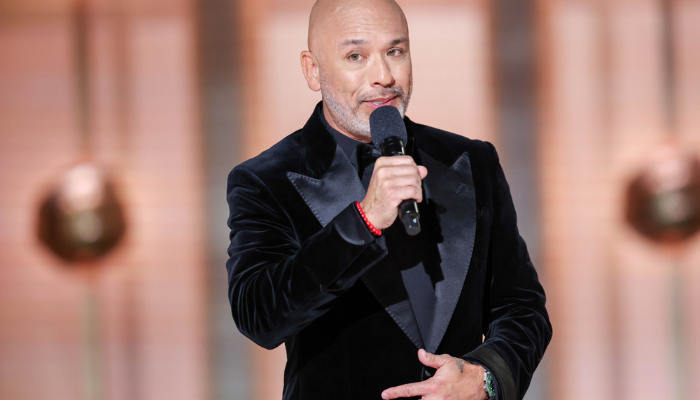 JoKoy on stage in black suit performing at Golden Globes