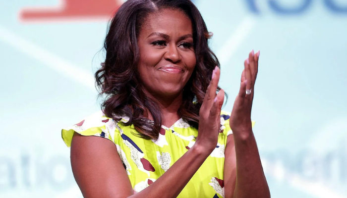 Michelle Obama clapping on stage