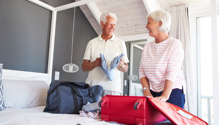 Senior couple packing for a trip together.