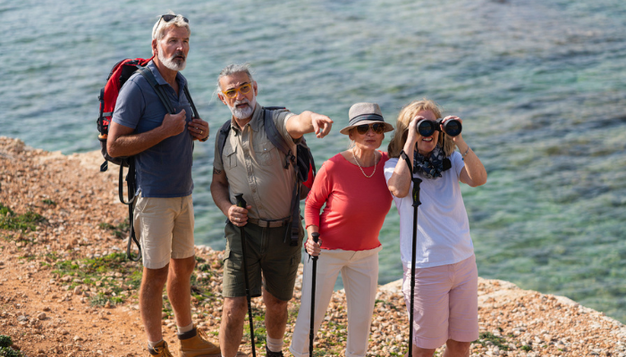 Happy active group of seniors exploring on vacation.