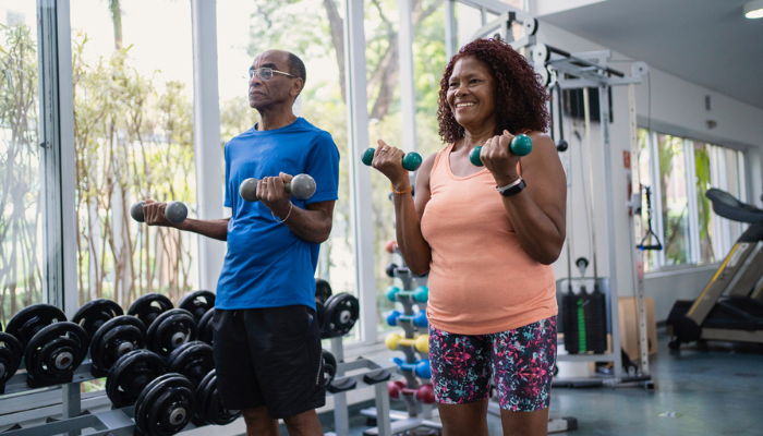 Senior African American couple happily working out together.