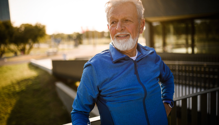 Older man taking a break from an outdoor run.