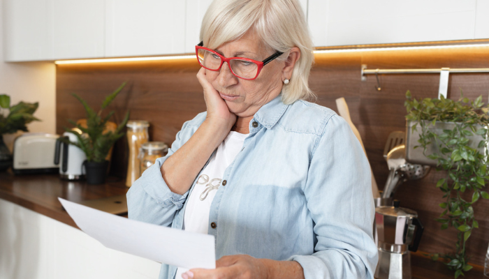 Older woman reviewing a social security disability insurance denial.