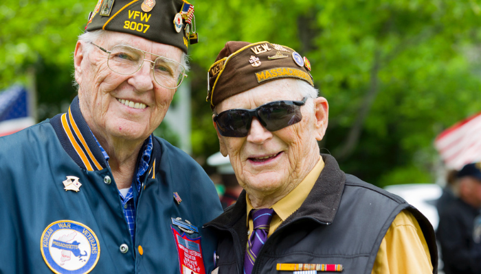 Two senior Veterans smiling for photo.
