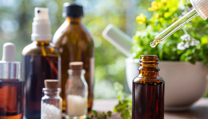 Alternative medicine bottles with herbs displayed.