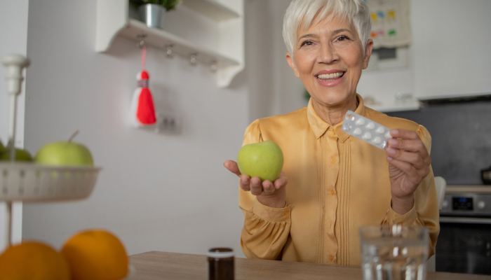 Senior woman showing supplements.