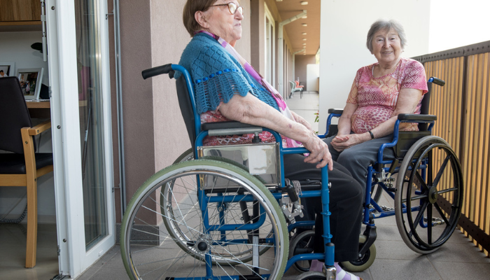 Disabled women talking in wheelchairs.