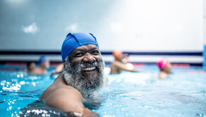 African American man smiling in swimming pool.