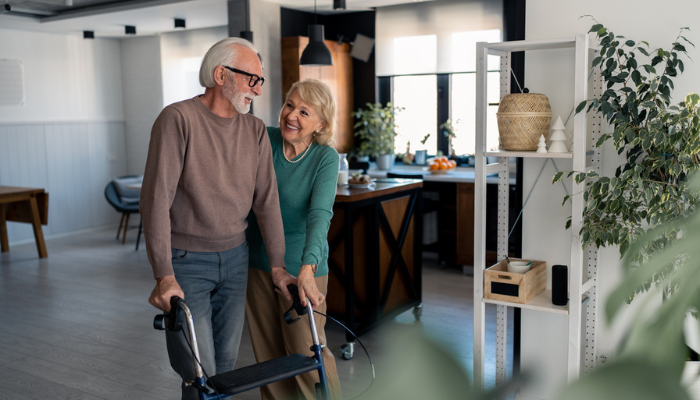 Happy senior couple looking into long term care using walker.