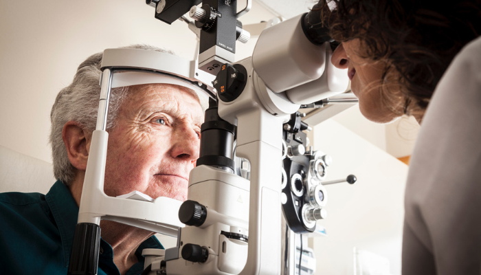 Older man getting a cataract eye exam.